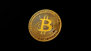 Photorealistic image of a Bitcoin coin with soft golden lighting against a dark background, showing intricate details of the Bitcoin symbol and metallic texture, no text or numbers visible